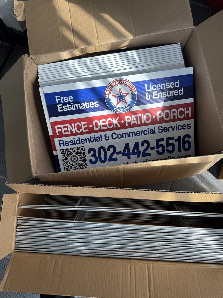 Box of printed yard signs for South Star Fence