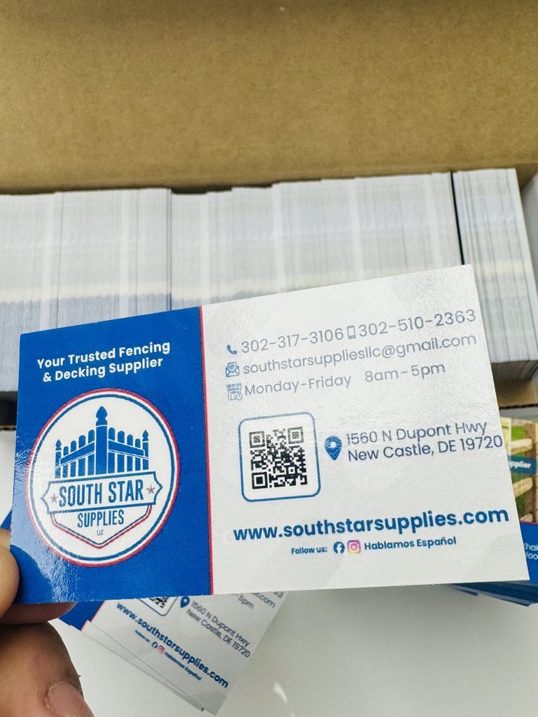 Printed business card for South Star Supplies, held in hand